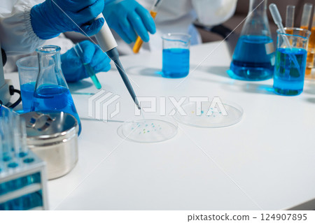 Scientist in laboratory study and analyze scientific sample. 124907895