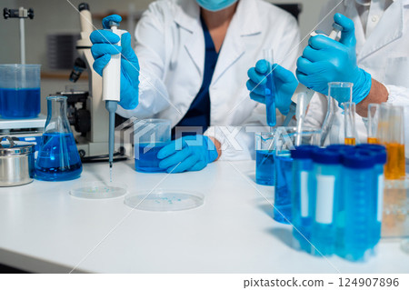 Scientist in laboratory study and analyze scientific sample. Scientist in laboratory study and analyze scientific sample. 124907896