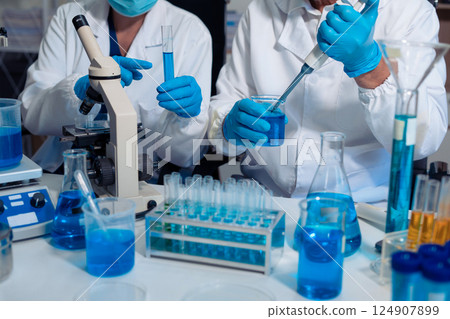 Scientist in laboratory study and analyze scientific sample. Scientist in laboratory study and analyze scientific sample. 124907899