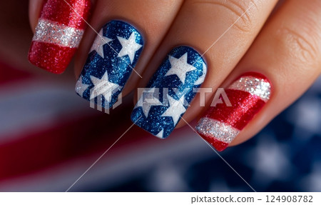 Close-up of a hand with patriotic nail art featuring stars and stripes in red, white, and blue. Concept of USA national holidays manicure design. 124908782