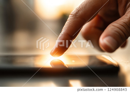 Finger touching smartphone screen closeup 124908843