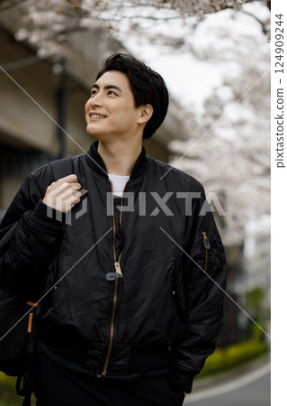 Men walking along cherry blossoms Men walking along cherry blossoms 124909244