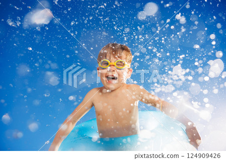 Happy child playing in waterpark. Kid having fun on summer vacation Happy child playing in waterpark. Kid having fun on summer vacation 124909426