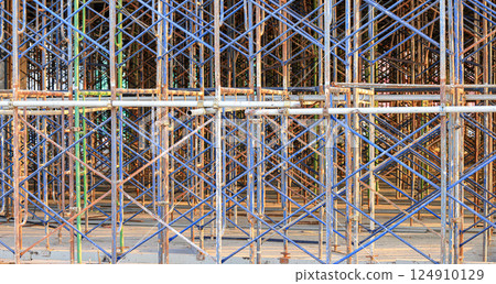 A large number of scaffoldings are used in large construction projects. Scaffolding for on construction site of the new building. A large number of scaffoldings are used in large construction projects. Scaffolding for on construction site of the new building. 124910129