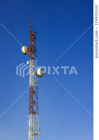 Detail of Transmitting and radio antenna Tower, steel Structure installed with dual polarization microwave antenna or Hyperbolic Antenna. Frame for modern metal building with beautiful sky. 124910142