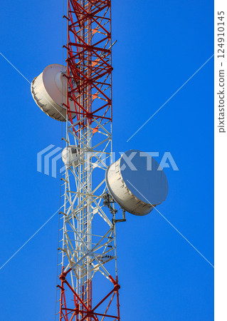 Detail of Transmitting and radio antenna Tower, steel Structure installed with dual polarization microwave antenna or Hyperbolic Antenna. Frame for modern metal building with beautiful sky. 124910145