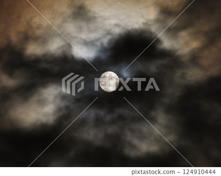 full moon seen through clouds full moon seen through clouds 124910444