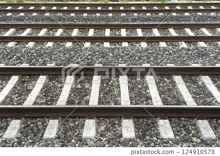 Railway Tracks Leading to the Horizon.A scenic view of multiple railway tracks stretching into the distance, emphasizing symmetry, structure, and the essence of travel.  124910578