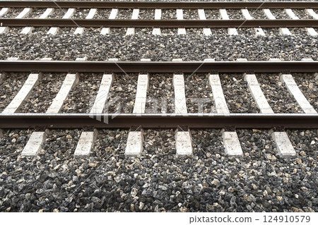 Railway Tracks Leading to the Horizon.A scenic view of multiple railway tracks stretching into the distance, emphasizing symmetry, structure, and the essence of travel. Railway Tracks Leading to the Horizon.A scenic view of multiple railway tracks stretching into the distance, emphasizing symmetry, structure, and the essence of travel. 124910579