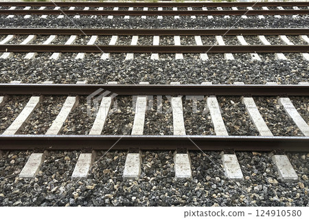 Railway Tracks Leading to the Horizon.A scenic view of multiple railway tracks stretching into the distance, emphasizing symmetry, structure, and the essence of travel.  124910580
