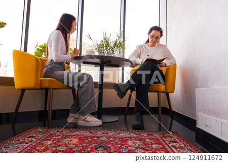 Young Caucasian entrepreneurs building a project roadmap during lunch. Concept of teamwork and business strategy. Bottom view Young Caucasian entrepreneurs building a project roadmap during lunch. Concept of teamwork and business strategy. Bottom view 124911672