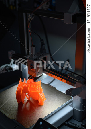 3D Printer Creating Vibrant Orange Prototype Model 3D Printer Creating Vibrant Orange Prototype Model 124911707