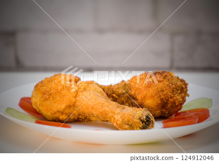 Crispy Fried Chicken Legs on a Plate 124912046