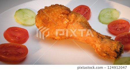 Fried Chicken Leg with Tomato and Cucumber 124912047