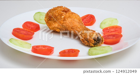 Two Fried Chicken Legs with Tomato and Cucumber 124912049