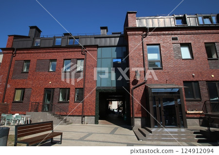 A solid brick building featuring stairs and a bench positioned in front of it A solid brick building featuring stairs and a bench positioned in front of it 124912094