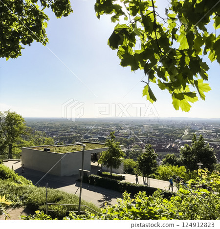 View of a city from a hill with a green roof on a building 124912823
