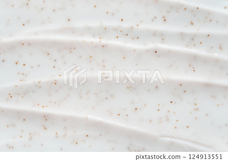 Smooth white cream texture with exfoliating brown specks for skincare and beauty 124913551