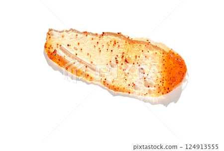 Close up of spicy sauce smear with red pepper flakes and textured cream on white Close up of spicy sauce smear with red pepper flakes and textured cream on white 124913555