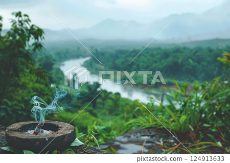 Cigarette butt is on the ground next to a body of water. Cigarette butt is on the ground next to a body of water. 124913633