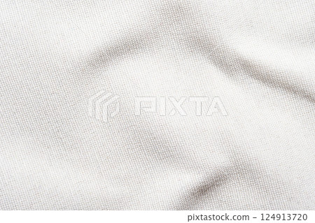 Close-up of textured white fabric with natural light and soft shadows Close-up of textured white fabric with natural light and soft shadows 124913720