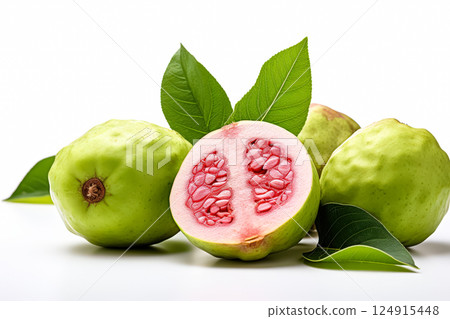 Pile of green guavas with one of them cut open. 124915448