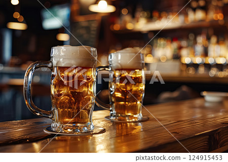 Two glasses of beer on a wooden bar counter 124915453