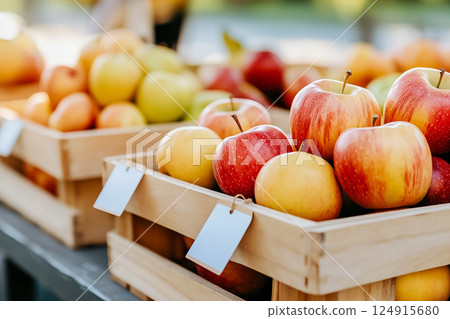 Fresh apples nestled in wooden crates, showcasing vibrant colors. Farmers market setting with sunlight illuminating the scene. Concept of local produce, healthy eating, fresh fruit. Fresh apples nestled in wooden crates, showcasing vibrant colors. Farmers market setting with sunlight illuminating the scene. Concept of local produce, healthy eating, fresh fruit. 124915680