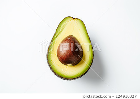 Large avocado is cut in half and placed on a white background Large avocado is cut in half and placed on a white background 124916327