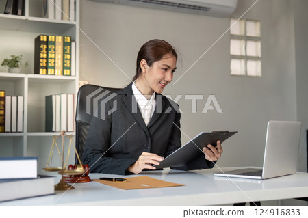 Female Attorney Analyzing Legal Documents on Clipboard Female Attorney Analyzing Legal Documents on Clipboard 124916833