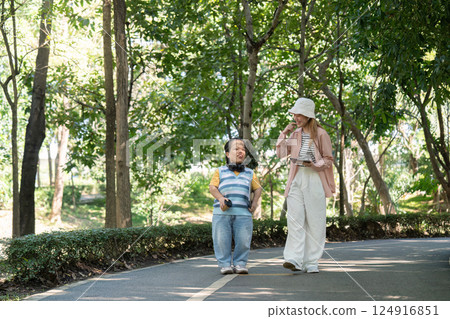 Joyful Stroll in the Park Embracing Diversity and Friendship with a Person with Achondroplasia 124916851