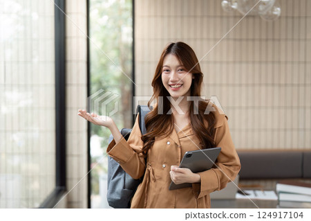 Confidence and Academic Achievement. A student showcasing enthusiasm about her university experience. 124917104