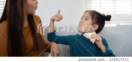 Back to School and Family Connection. Mother and daughter share a fun snack moment while preparing for school. 124917311