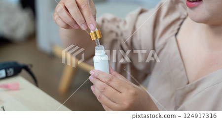 Beauty Essentials and Makeup Application. Filling a serum bottle for a personalized skincare routine. Beauty Essentials and Makeup Application. Filling a serum bottle for a personalized skincare routine. 124917316