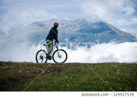 Riding mountain bike on beautiful mountain top Riding mountain bike on beautiful mountain top 124917539