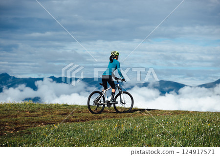 Riding mountain bike on beautiful mountain top Riding mountain bike on beautiful mountain top 124917571