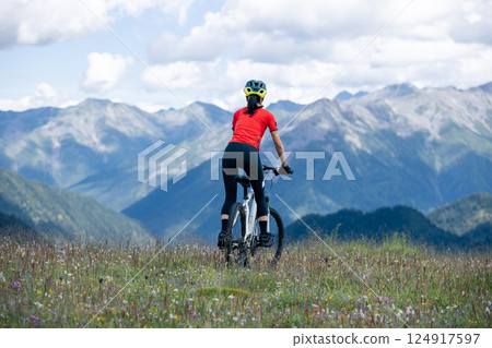 Woman riding mountain bike in the beautiful mountains 124917597