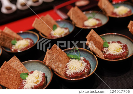 Exquisite beef tartare elegantly presented in ceramic bowls 124917706