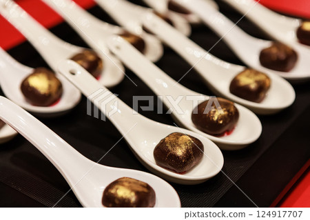 Elegant gourmet chocolate truffles with a touch of edible gold dust, 124917707