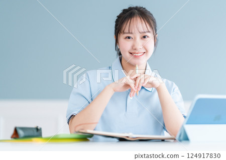 Female student taking a lesson on a tablet PC 124917830