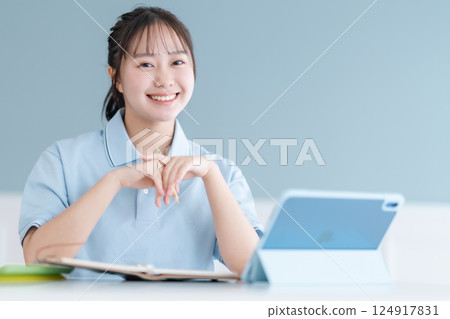 Female student taking a lesson on a tablet PC 124917831