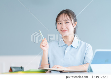 Female student taking a lesson on a tablet PC 124917832