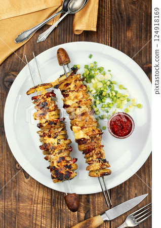 Bacon and fried potatoes on wooden surface, BBQ. 124918169