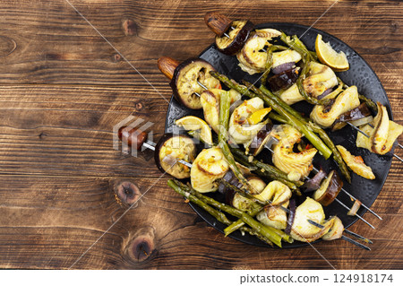 Delicious food on skewers, fish kebabs. 124918174