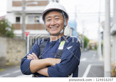 Senior worker standing with a smile Senior worker standing with a smile 124918207