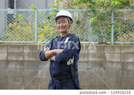 Senior worker standing with a smile 124918210