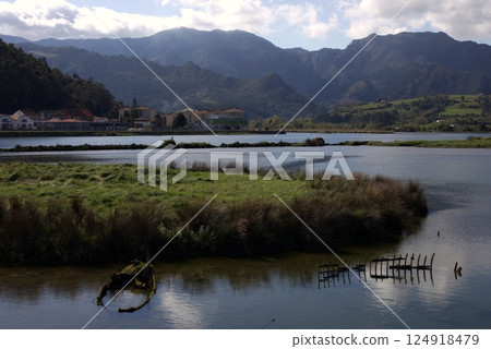 Old abandoned boat wrecks in wetland with scenic mountain backdrop in Ribadesella, Asturias, northern Spain Old abandoned boat wrecks in wetland with scenic mountain backdrop in Ribadesella, Asturias, northern Spain 124918479