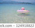 A Little Girl Floating in the Sea 124918822