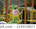 A Little Girl Playing at a Sunny Park 124918823
