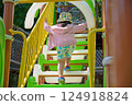 A Little Girl Playing at a Sunny Park 124918824